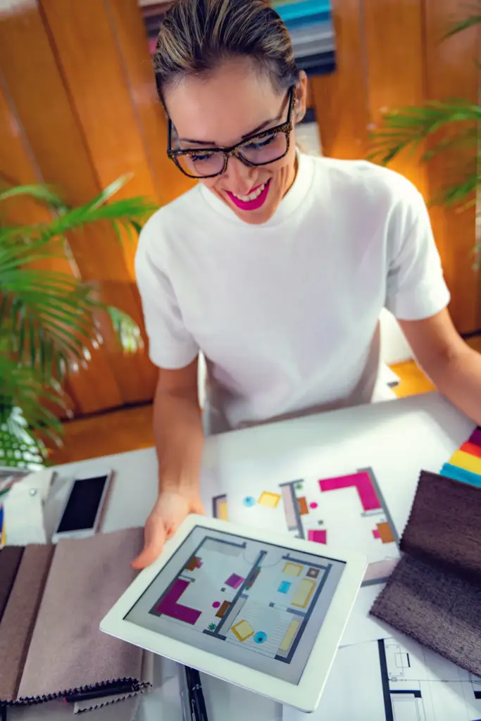 Lady looking at a flooring plan on an ipad.
